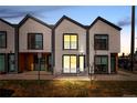 Contemporary townhome with a modern design, clean lines, and inviting curb appeal at dusk with warm interior lights at 1907 W Elk Pl # 4, Denver, CO 80211