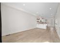 Open-concept living area with hardwood floors and a bright kitchen space at 1907 W Elk Pl, Denver, CO 80211