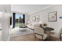 Bright living room with hardwood floors, modern decor, and large windows with backyard view at 1907 W Elk Pl, Denver, CO 80211