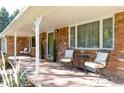 Inviting front porch with brick flooring and comfortable seating, perfect for enjoying the outdoors at 5915 S Race St, Greenwood Village, CO 80121