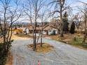 Expansive lot and landscape surrounding home; long driveway and mature trees surround the home at 14290 W 54Th Ave, Arvada, CO 80002