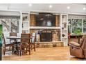 Cozy living room features a stone fireplace, built-in shelves, and natural light with hardwood floors at 14290 W 54Th Ave, Arvada, CO 80002