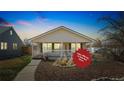 Charming single-story home featuring a cozy front porch, mature landscaping, and a fresh exterior paint job at 2019 S Fox St, Denver, CO 80223