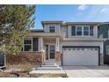Charming two-story home with stone accents, a covered porch, and an attached two-car garage at 23841 E Alabama Dr, Aurora, CO 80018