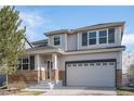 Charming two-story home with stone accents, a covered porch, and an attached two-car garage at 23841 E Alabama Dr, Aurora, CO 80018