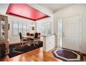 Elegant dining room with hardwood floors, shuttered windows and unique ceiling detail at 23545 E Phillips Pl, Aurora, CO 80016
