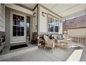 Inviting porch seating area with wicker furniture and a view of the neighborhood at 23545 E Phillips Pl, Aurora, CO 80016
