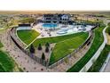 Aerial view of the community center featuring a pool, playground, and well-maintained green spaces at 27655 E Geddes Pl, Aurora, CO 80016