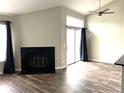 Relax in this living room with its inviting fireplace, lots of light, and hardwood floors at 1470 S Quebec Way # 275, Denver, CO 80231