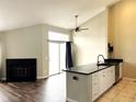 Bright living room features a fireplace, a ceiling fan, and sliding glass doors with stylish curtains at 1470 S Quebec Way # 275, Denver, CO 80231