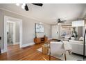 Cozy living room with hardwood floors, ceiling fan, and neutral color palette at 1449 Clinton St, Aurora, CO 80010