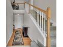 Inviting foyer with hardwood floors, staircase, and stylish decor leading to the upper level at 2631 S Flanders Ct, Aurora, CO 80013