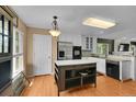 Bright kitchen with an island, stainless steel appliances, and a view of the backyard at 2631 S Flanders Ct, Aurora, CO 80013