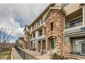 Attractive condo building with beautiful stone facade and private covered entry at 452 Black Feather Loop # 612, Castle Rock, CO 80104