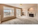 Bright living room featuring a fireplace, decorative shelving and sliding glass doors to balcony at 452 Black Feather Loop # 612, Castle Rock, CO 80104