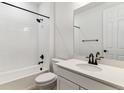 Modern bathroom with white subway tile, a shower with black fixtures, and a quartz vanity at 39172 Clymer St, Elizabeth, CO 80107