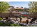 Backyard patio with furniture, rock border and a view of other homes and distant mountains at 4000 Donnington Cir, Castle Rock, CO 80104