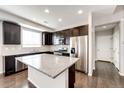 Spacious kitchen island with granite countertop, stainless steel appliances, and ample cabinet space at 16075 E Elk Pl, Denver, CO 80239