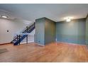 Living room with hardwood floors and a staircase leading to the upper level at 6844 S Broadway, Littleton, CO 80122