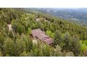 Secluded home surrounded by lush forest, offering privacy and tranquility at 11094 Thomas Dr, Conifer, CO 80433