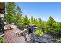 Outdoor entertaining is easy on this expansive back deck with grill and seating at 11094 Thomas Dr, Conifer, CO 80433
