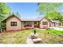 Inviting home with a well-manicured front yard, two-car garage and charming accents, perfect for curb appeal at 11094 Thomas Dr, Conifer, CO 80433