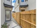 Townhouse entrance with private gated walkway and landscaping at 1717 Grove St, Denver, CO 80204
