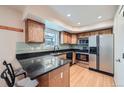 Updated kitchen with stainless steel appliances, granite countertops, and modern backsplash at 3334 Navajo St, Denver, CO 80211