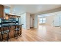 Open-concept living space featuring hardwood floors, natural light, and seamless flow from kitchen to living area at 3334 Navajo St, Denver, CO 80211