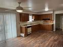 Cozy kitchen with wooden cabinets and laminate flooring at 1530 Whippoorwill Dr, Lakewood, CO 80215