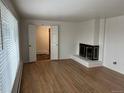 Inviting living room featuring a fireplace and gleaming hardwood floors at 1530 Whippoorwill Dr, Lakewood, CO 80215