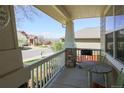 Cozy front porch with stone pillars, outdoor seating, and a view of the neighborhood street at 3754 Broadview Pl, Castle Rock, CO 80109