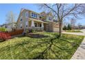 Exterior shot of a charming home with a stone facade, a well-manicured lawn, and a spacious yard at 3754 Broadview Pl, Castle Rock, CO 80109