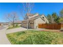 Side view of a home with a three-car garage, a fenced yard, and well-maintained landscaping at 3754 Broadview Pl, Castle Rock, CO 80109