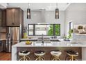 Modern kitchen with stainless steel appliances, white countertops, and stylish bar stool seating at 485 E Arizona Ave, Denver, CO 80210