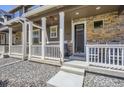 Inviting covered front porch with seating and decorative touches at 7022 Todd Ct, Frederick, CO 80530