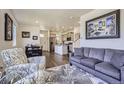 Bright living room featuring modern decor, hardwood floors, and ample natural light at 7022 Todd Ct, Frederick, CO 80530