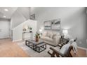 Bright living room features neutral decor, staircase, and wood flooring at 4042 E Geddes Cir, Centennial, CO 80122