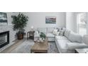 Cozy living room with a comfortable sofa, fireplace, and ample natural light at 329 Lodgewood Ln, Lafayette, CO 80026