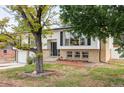 Charming home featuring a well-maintained yard, a two-car garage, and a classic exterior design at 12680 W 38Th Dr, Wheat Ridge, CO 80033