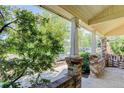 Covered front porch features brick columns and a relaxing space to enjoy the outdoors at 4032 Lipan St, Denver, CO 80211