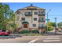 Multi-story building with multiple balconies, street access, and green landscaping at 3299 Lowell Blvd # 102, Denver, CO 80211
