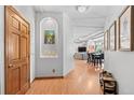 Hallway features wood floors and an arched display nook with artwork and decorative items at 3299 Lowell Blvd # 102, Denver, CO 80211