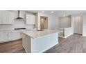 Modern kitchen featuring white cabinetry, stainless steel appliances, and a large center island perfect for cooking at 3443 N Gold Bug Ct, Aurora, CO 80019