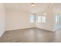 Bright living room featuring wood floors, neutral walls, and large windows with a view at 13826 Honey Hush Trl, Parker, CO 80134