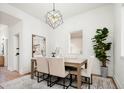 Elegant dining room with modern lighting, stylish rug, and a view to an adjacent room at 3519 Newton St, Denver, CO 80211