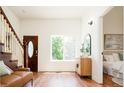 Inviting living room with hardwood floors, staircase, and a view of the outdoors through a bright window at 3519 Newton St, Denver, CO 80211