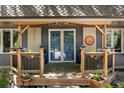 Inviting covered front porch with a seating area, plants, and attractive exterior details at 8427 Chase Dr, Arvada, CO 80003