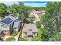 Charming home with landscaped yard, mature trees, and solar panels, nestled in a peaceful neighborhood at 2819 W 43Rd Ave, Denver, CO 80211
