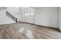 Bright living space with staircase, hardwood floors, and lots of natural light at 9257 Truckee Ct, Commerce City, CO 80022